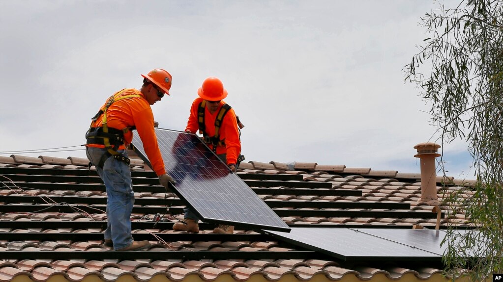 Electricians install solar panels