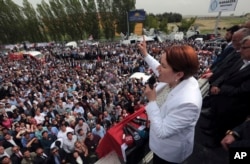 FILE - Meral Aksener addresses supporters of Turkey's opposition Nationalist Movement Party, MHP, as riot police sealed off a hotel to prevent thousands of dissidents in the party from holding a congress to oust Devlet Bahceli, leader for the last two decades, in Ankara, Turkey, May 15, 2016.