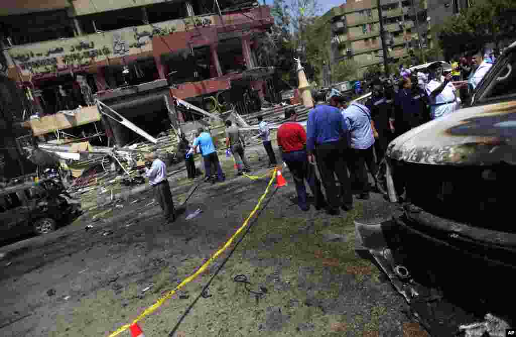 Security personnel gather at a site of an explosion near the convoy of the Egyptian Interior Minister Mohamed Ibrahim, Cairo, Sept. 5, 2013.