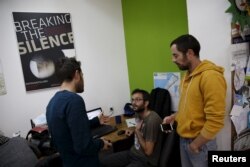 Employees work at the offices of "Breaking the Silence" in Tel Aviv, Israel, December 16, 2015. An ultra-nationalist Israeli group has published a video accusing the heads of four Israel's leading human rights organisations, including "Breaking the Silence," of supporting terror.