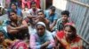 Volunteers in a slum in Dhaka listen to a lecture on reproductive health. (Amy Yee/VOA)