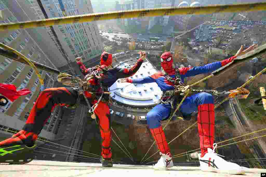 Acrobats dressed as superheroes come down from the roofs to make a surprise greeting at the windows of the rooms of the little patients in pediatrics and of all the patients, at the San Paolo hospital in Milan, Italy.
