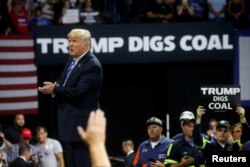 President Donald Trump acknowledges coal miners during a Make America Great Again rally at the Civic Center in Charleston, West Virginia, Aug. 21, 2018.