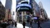 People walk past the Nasdaq MarketSite in New York, April 5, 2016.