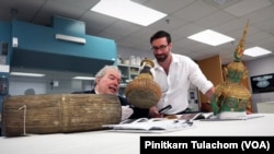 Curators, Dr. Paul Michael Taylor and Dr.Robert Pontsioen studying the Thai collection at the Smithsonian's Museum Support Center.Suitland, MD.