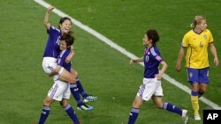 Homare Sawa (L) of Japan celebrates with her teammate Nahomi Kawasumi after scoring against Sweden during their Women's World Cup semi-final soccer match in Frankfurt, July 13, 2011