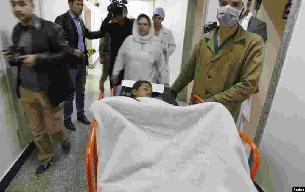 A boy receives treatment at a military hospital in Kabul, after being wounded during a suicide attack at a volleyball match on Sunday in the Yahya Khel district of Paktika province, Nov. 24, 2014.