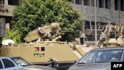Egyptian army armoured personnel carriers (APC) are stationed outside the Aguza Military Hospital in Cairo, August 19, 2013.