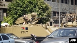 Egyptian army armored personnel carriers are stationed outside the Aguza Military Hospital in Cairo, August 19, 2013.