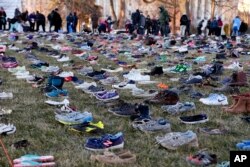 In this display in Washington, empty pairs of shoes — symbolizing the children killed by guns in the United States since the Sandy Hook shootings in 2012 — sit on the southeast lawn of the U.S. Capitol, March 13, 2018.