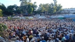 Rohingya refugees offer funeral prayers for community leader Mohib Ullaha after he was killed outside his office in a refugee camp.