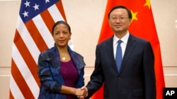 U.S. National Security Adviser Susan Rice, left, and Chinese State Councilor Yang Jiechi, right, shake hands as they pose for a photo at the Diaoyutai State Guesthouse in Beijing, Monday, July 25, 2016.