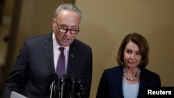 FILE - Senate Minority Leader Chuck Schumer and House Minority Leader Nancy Pelosi speak at a news conference.