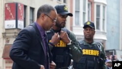 Officer Caesar Goodson, left, one of six Baltimore city police officers charged in connection with the death of Freddie Gray, arrives at a courthouse before receiving a verdict in his trial in Baltimore, June 23, 2016.