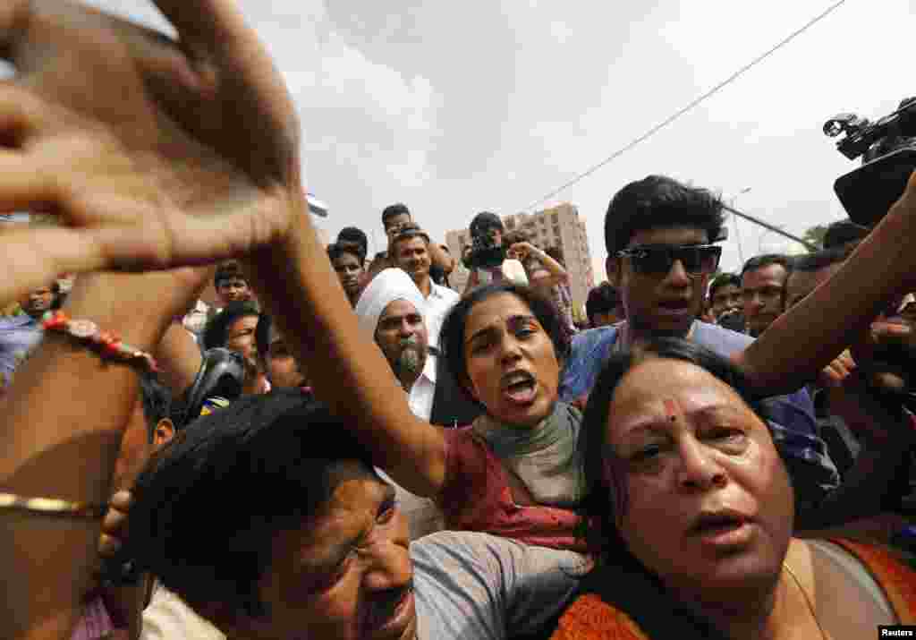 Protesters shout slogans outside a court in New Delhi, Sept. 11, 2013. 