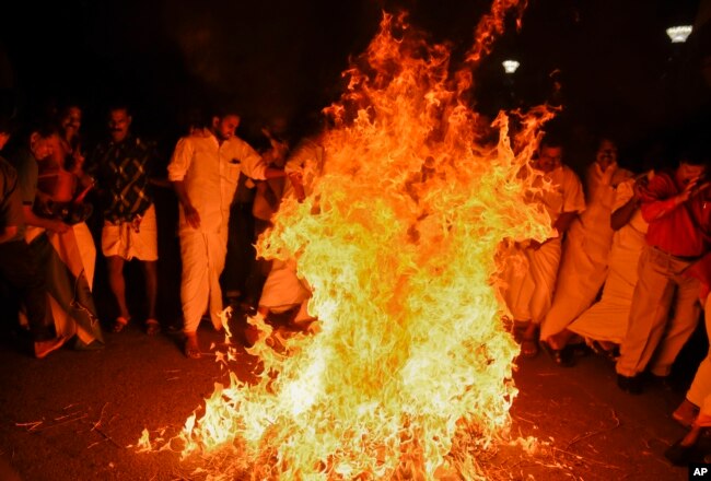 Opposition Congress party activists burn an effigy of Chief Minister Pinarayi Vijayan reacting to reports of two women of menstruating age entering the Sabarimala temple in Thiruvananthapuram, Kerala, India, Jan. 2, 2018.