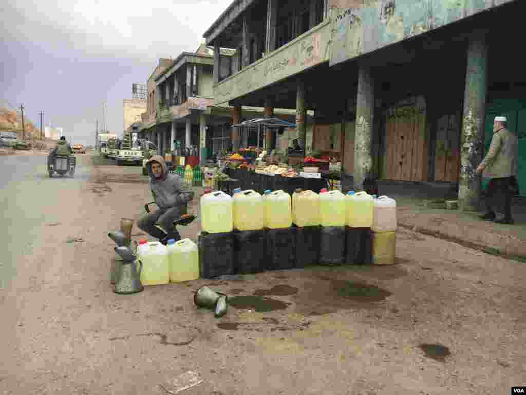 جزائر میں سڑک کے کنارے ایک نوجوان پیٹرول فروخت کر رہا ہے