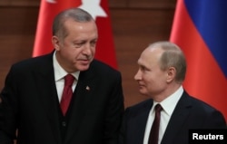 FILE - Presidents Tayyip Erdogan of Turkey and Vladimir Putin of Russia hold a joint news conference after their meeting in Ankara, Turkey, April 4, 2018.