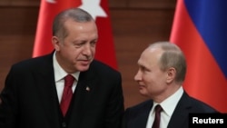 FILE - Presidents Tayyip Erdogan of Turkey and Vladimir Putin of Russia hold a joint news conference after their meeting in Ankara, Turkey, April 4, 2018.