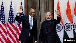 FILE - U.S. President Barack Obama and India's Prime Minister Narendra Modi, right, wave during a photo opportunity ahead of their meeting at Hyderabad House, New Delhi, Jan. 25, 2015. 