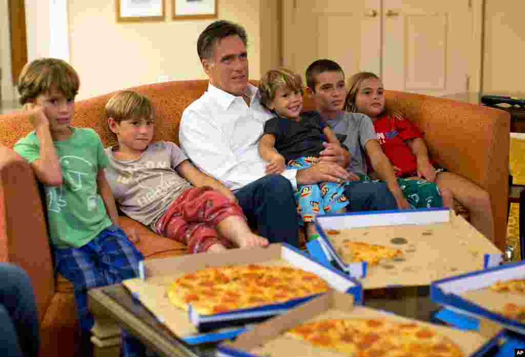 August 29: Republican presidential candidate Mitt Romney watches the Republican National Convention with his grandchildren from his hotel room in Tampa, Florida.