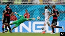 United States' goalkeeper Tim Howard is unable to stop a shot by Thomas Mueller, scoring Germany's first goal during the group G World Cup soccer match between the United States and Germany in Recife, Brazil, June 26, 2014.