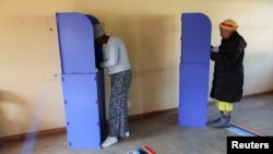 Voters fill out ballots at a polling station during the Eswatini's parliamentary elections in Mbabane, Eswatini, Sept. 29, 2023