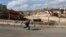 A boy runs past a road under construction in the Arab neighborhood of Beit Safafa in Jerusalem February 28, 2013.