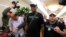 Former NBA basketball star Dennis Rodman, center, arrives at Sunan International Airport on June 13, 2017, in Pyongyang, North Korea. 
