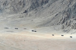 FILE - Indian soldiers walk at the foothills of a mountain range near Leh, the joint capital of the union territory of Ladakh, June 25, 2020.