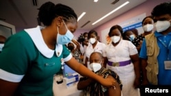 FILE - Director General of the Ghana Health Service Dr. Patrick Kuma-Aboagye receives the coronavirus disease (COVID-19) vaccine during the vaccination campaign at the Ridge Hospital in Accra, Ghana, March 2, 2021.