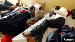 Wounded Congolese army fighters rest inside a ward as they receive treatment at the HEAL Africa teaching hospital in Goma, in the eastern Democratic Republic of Congo, Aug. 27, 2013.