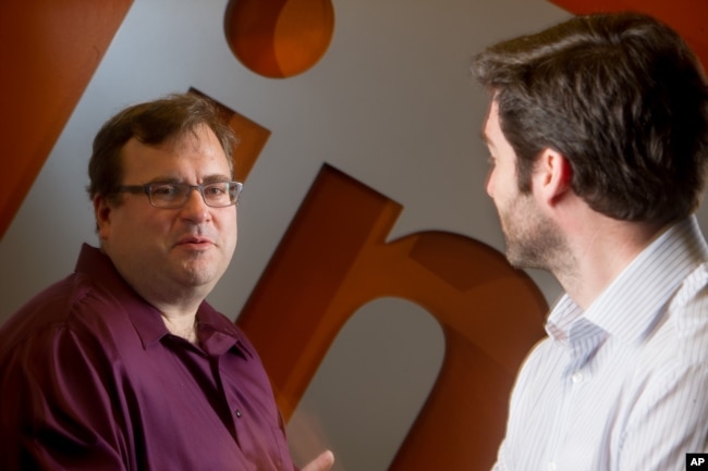 FILE - LinkedIn co-founder Reid Hoffman, left, sits with CEO Jeff Weiner in the lobby of LinkedIn's Mountain View, Calif., headquarters on Tuesday, May 7, 2013. (AP Photo/Noah Berger)
