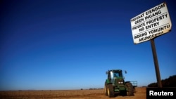 FILE- A "no entry" sign is seen at an entrance of a farm outside Witbank, Mpumalanga province, South Africa, July 13, 2018. South African President Cyril Ramaphosa announced on Aug. 1 that the ruling African National Congress plans to change the constitution to allow the expropriation of land without compensation.