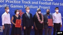 A photo taken on April 22, 2022, shows China's ambassador to the Solomon Islands, Li Ming, center left, and Solomons Prime Minister Manasseh Sogavare, center right, with other officials during the opening ceremony of a China-funded national sports stadium in Honiara.