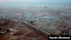 FILE - The first train of the new Hokuriku Shinkansen runs near Shin-Takaoka Station in Takaoka, Toyama prefecture, March 14, 2015. (REUTERS/Kyodo)