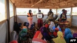 Members from NGO, Plan International, give classes to women and young girl during a field visit by Filippo Grandi, the United Nations High Commissioner for Refugees (UNHCR), in Maroua, Cameroon, April 28, 2022.