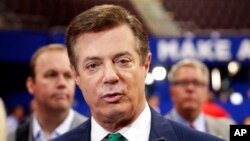 FILE - In this July 17, 2016, photo, then-Donald Trump campaign chairman Paul Manafort talks to reporters on the floor of the Republican National Convention, in Cleveland.