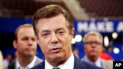 FILE - In this July 17, 2016, photo, then-Donald Trump campaign chairman Paul Manafort talks to reporters on the floor of the Republican National Convention, in Cleveland.