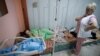 FILE - Patients take shelter in the basement of a perinatal center as air raid siren sounds are heard amid Russia's invasion, in Kyiv, Ukraine, March 2, 2022. 