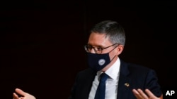 FILE - Counselor of the US State Department Derek Chollet gestures at the end of a talk with journalists, in Bucharest, Romania, Feb.9, 2022.