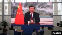 FILE - A screen shows Chinese President Xi Jinping delivering a keynote speech at the opening ceremony of the Boao Forum for Asia, via video link, at a media center in Boao, Hainan province, China, April 21, 2022.