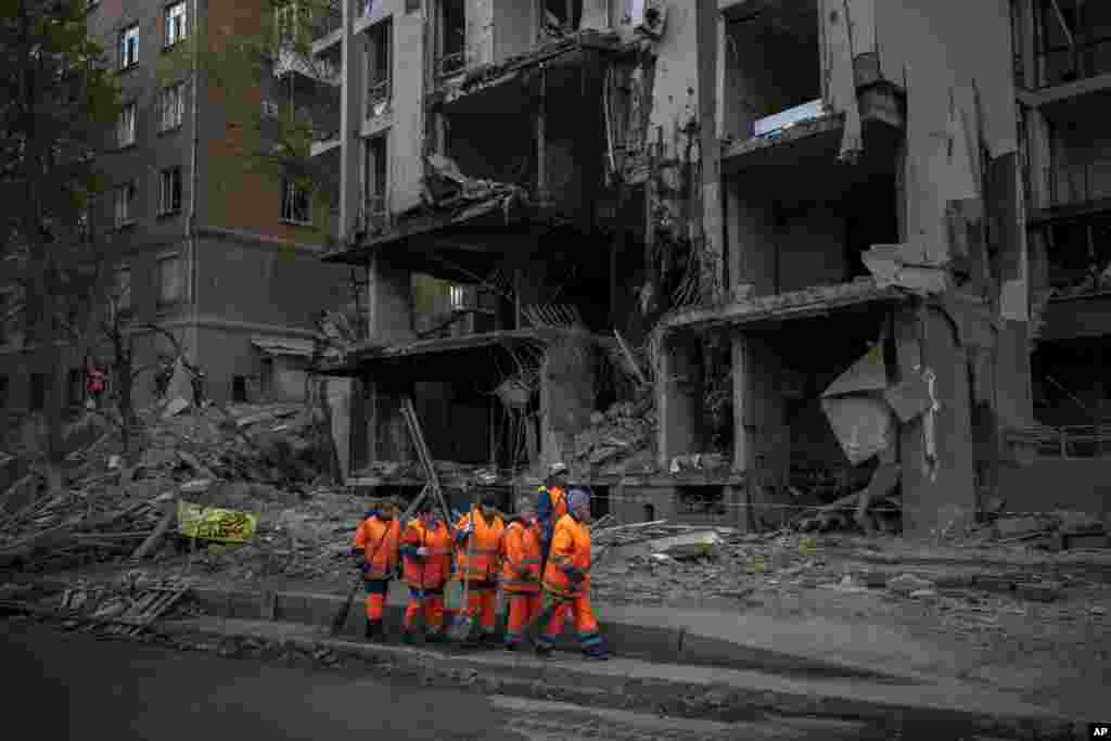 Clean-up crews prepare to work at the site of an explosion in Kyiv, Ukraine on April 29, 2022. Russia struck the Ukrainian capital of Kyiv shortly after a meeting between President Volodymyr Zelenskyy and U.N. Secretary-General António Guterres on Thursda