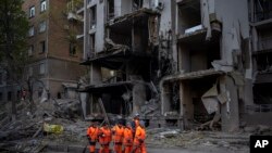 Clean-up crews prepare to work at the site of an explosion in Kyiv, Ukraine on April 29, 2022. Russia struck the Ukrainian capital of Kyiv shortly after a meeting between President Volodymyr Zelenskyy and U.N. Secretary-General António Guterres on Thursda