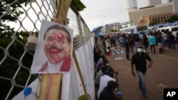 A defaced portrait of Prime Minister Mahinda Rajapaksa is seen at an ongoing protest site, outside the president's office in Colombo, Sri Lanka, April 23, 2022. 