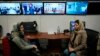 FILE - Afghan journalists Banafsha Binesh, right, speaks with her colleague Wheeda Hassan, at TOLO TV's newsroom in Kabul, Feb. 8, 2022.