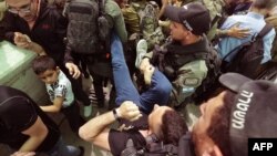 Israeli security forces evacuate a Palestinian man who was denied passage at a checkpoint to reach the city of Jerusalem to attend the last Friday prayers of Ramadan in the al-Aqsa mosque compound, in Bethlehem in the occupied West Bank, April 29, 2022. 