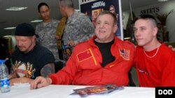FILE - Josip Peruzovic, aka Nikolai Volkoff, a former World Championship Wrestling and World Wrestling Federation superstar, meets U.S. soldiers at Camp As Sayliyah in Qatar, Jan. 21, 2008.
