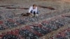 A man removes broken glass scattered on the carpet of a mosque damaged in Tuesday&#39;s blast in Beirut, Lebanon.