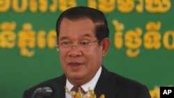 In this Feb. 7, 2021, file photo, Cambodian Prime Minister Hun Sen delivers a speech during a handover ceremony at Phnom Penh International Airport, in Phnom Penh, Cambodia. 